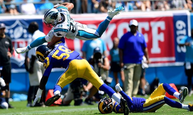 Christian McCaffrey #22 of the Carolina Panthers hurdles over Eric Weddle #32 of the Los Angeles Ra...