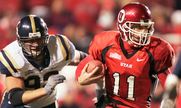 Quarterback Alex Smith #11 of the University of Utah scrambles for a first down as John Denney #92 ...