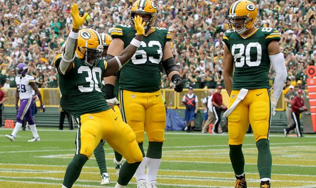 Running back Jamaal Williams #30 of the Green Bay Packers and teammates celebrate a touchdown again...