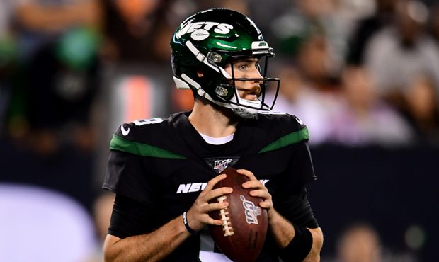 Luke Falk #8 of the New York Jets drops back to pass during their game against the Cleveland Browns...