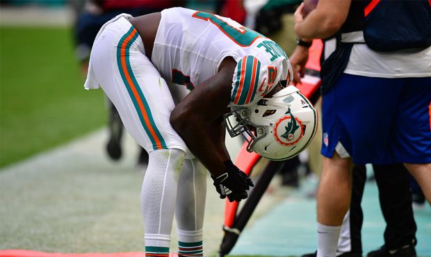 Kalen Ballage #27 of the Miami Dolphins reacts after causing an intereception in the foruth quarter...