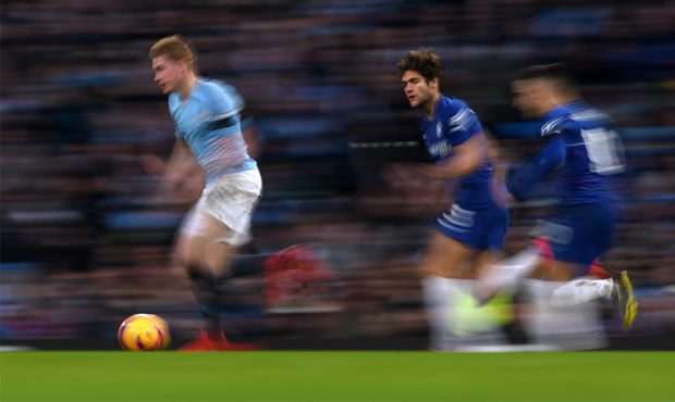 Kevin De Bruyne of Machester City runs on the ball past Marcos Alonso and Eden Hazard of Chelsea du...