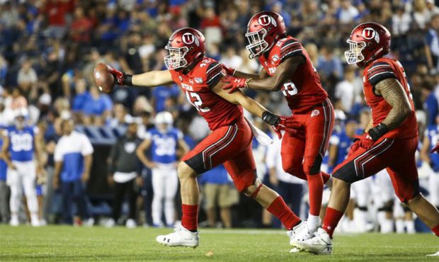 Utah defensive end Mika Tafua (42) runs out of the pile with a recovered fumble giving the Utes pos...