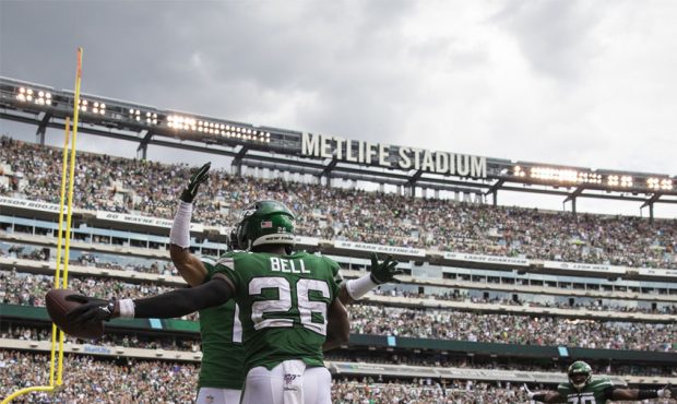 Le'Veon Bell #26 of the New York Jets celebrates scoring a touchdown on a pass thrown by Sam Darnol...