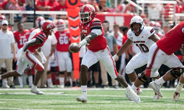 Tyler Huntley #1 of the Utah Utes looks to hand off the ball against the Northern Illinois Huskies ...
