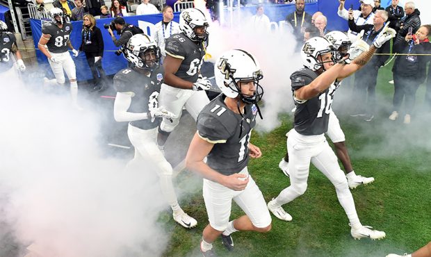 Wide receiver Tre Nixon #16 and place kicker Matthew Wright #11 of the UCF Knights take the field b...
