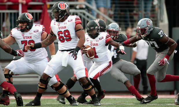 Quarterback Tyler Huntley #1 of the Utah Utes carries the ball against the Washington State Cougars...