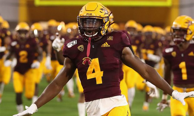 Defensive back Evan Fields #4 of the Arizona State Sun Devils runs onto the field before the NCAAF ...