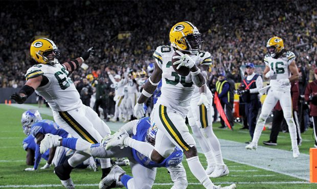 Jamaal Williams #30 of the Green Bay Packers scores a touchdown in the second quarter against the D...
