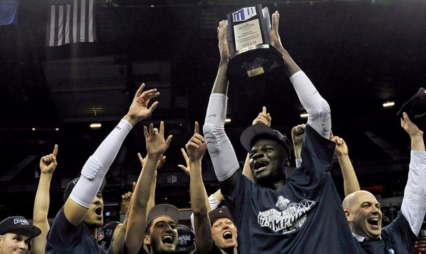 Neemias Queta #23 of the Utah State Aggies celebrates with his team after defeating the San Diego S...