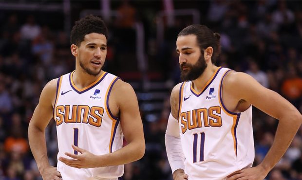 Devin Booker #1 of the Phoenix Suns talks with Ricky Rubio #11 during the second half of the NBA ga...