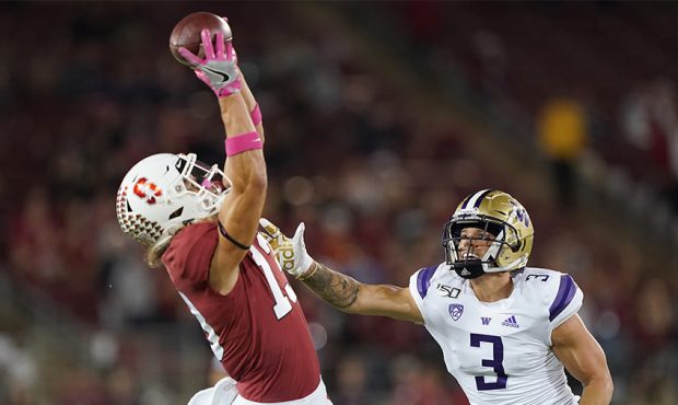 Simi Fehoko #13 of the Stanford Cardinal catches a pass over Elijah Molden #3 of the Washington Hus...