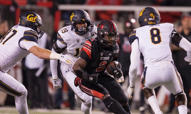Zach Moss #2 of the Utah Utes rushes the ball against JH Tevis #47, Cameron Goode #19, and Kuany De...