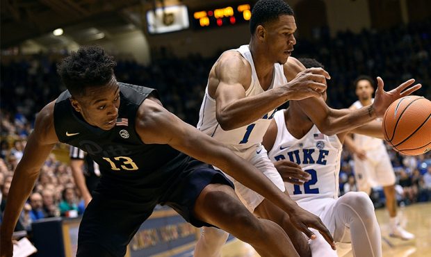 Khameron Davis #13 of the Pittsburgh Panthers battles Trevon Duval #1 and Javin DeLaurier #12 of th...