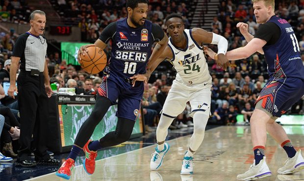 Ramone Moore #10 of the Adelaide 36ers drives around Miye Oni #25 of the Utah Jazz during a game ag...