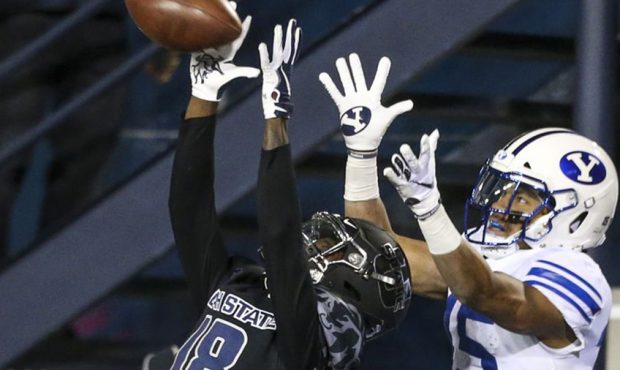 Utah State Aggies cornerback Cam Lampkin (18) intercepts a ball intended for Brigham Young Cougars ...