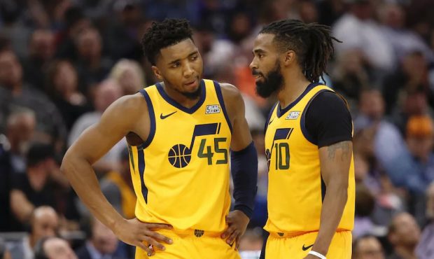 Utah Jazz guards Donovan Mitchell, left, and Mike Conley talk during a break in the action during t...