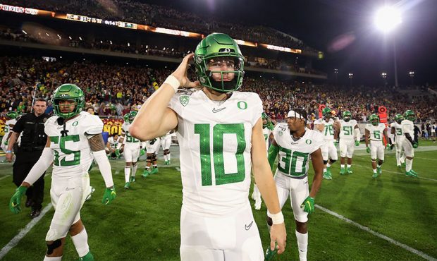 Quarterback Justin Herbert #10 of the Oregon Ducks walks off the field after being defeated by the ...