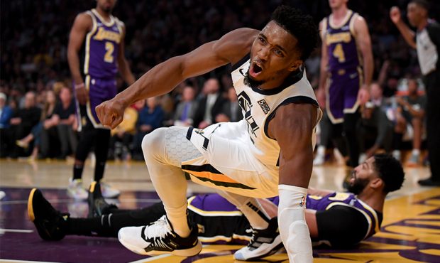 Donovan Mitchell #45 of the Utah Jazz reacts after his shot and foul by Anthony Davis #3 of the Los...