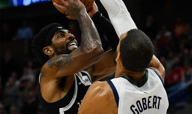 Kyrie Irving #11 of the Brooklyn Nets shoots over Rudy Gobert #27 of the Utah Jazz during a game at...
