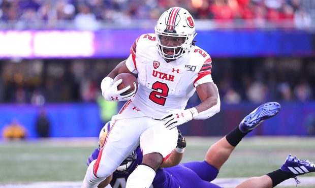Zack Moss #2 of the Utah Utes runs with the ball in the second quarter against Jackson Sirmon #43 o...