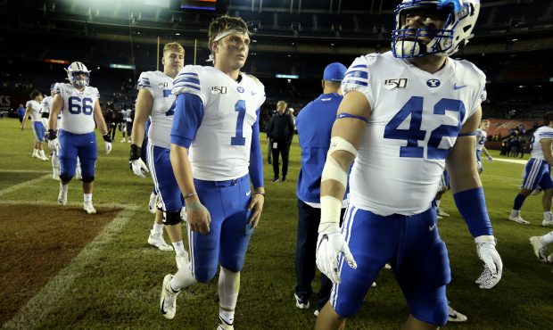 BYU football players, including quarterback Zach Wilson (1) and tight end Kyle Griffitts (42), leav...