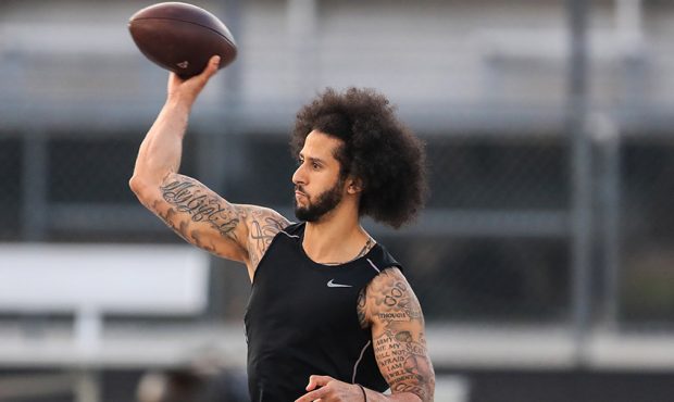 Colin Kaepernick makes a pass during a private NFL workout held at Charles R Drew high school on No...