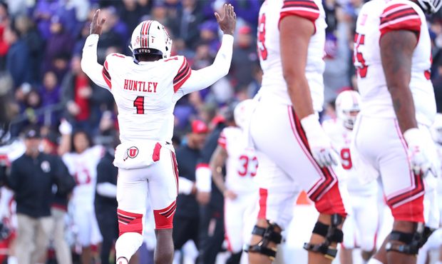 Tyler Huntley #1 of the Utah Utes signals for a touchdown after throwing a nine yard touchdown pass...
