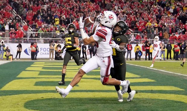 Wide receiver Samson Nacua #45 of the Utah Utes catches a touchdown pass over safety Jevon Holland ...