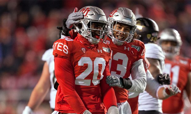 Devin Lloyd #20 of the Utah Utes is congratulated by teammate Francis Bernard #13 after sacking Ste...