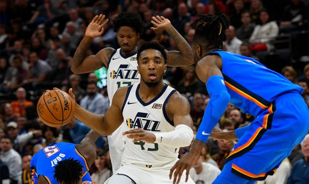 Donovan Mitchell #45 of the Utah Jazz attempts to drive around Nerlens Noel #9 of the Oklahoma City...