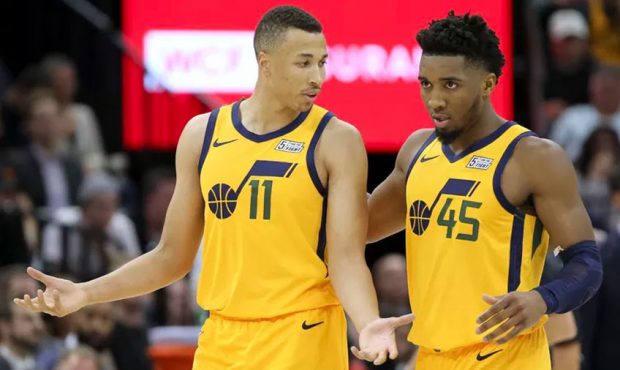 Utah Jazz guard Dante Exum (11) and Utah Jazz guard Donovan Mitchell (45) talk during a break in an...