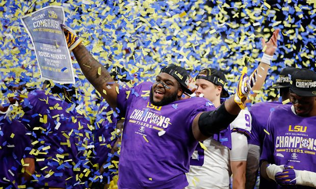 Tyler Shelvin #72 of the LSU Tigers celebrates defeating the Georgia Bulldogs 37-10 to win the SEC ...