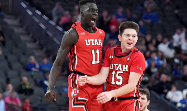 Both Gach #11 and Rylan Jones #15 of the Utah Utes celebrate after Jones hit a 3-pointer against th...