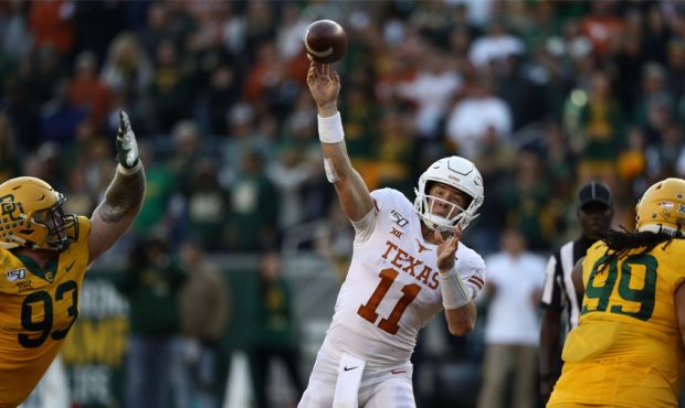 Sam Ehlinger #11 of the Texas Longhorns throws against the Baylor Bears in the second half at McLan...