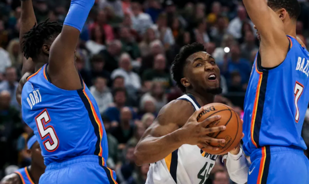 Utah Jazz guard Donovan Mitchell (45) is boxed in by Oklahoma City Thunder guard Luguentz Dort (5) ...
