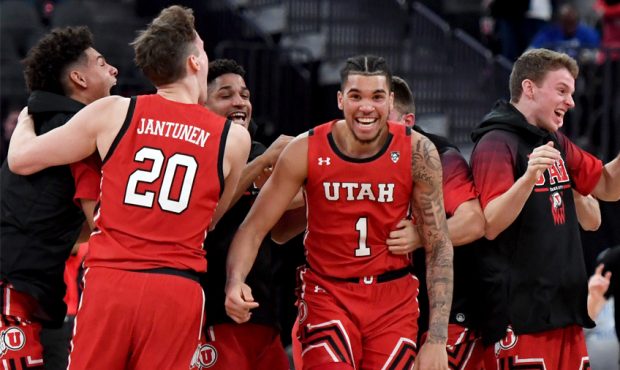 Utah Utes players, including Timmy Allen #1, celebrate on the court after the team's 69-66 victory ...