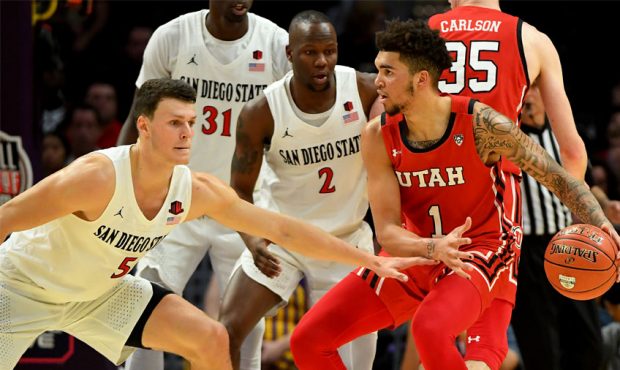 Yanni Wetzell #5 of the San Diego State Aztecs guards Timmy Allen #1 of the Utah Utes in the first ...