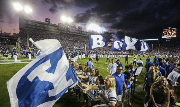 The BYU Spirit Squad waves their team flags after running out  before the rivalry game between BYU ...