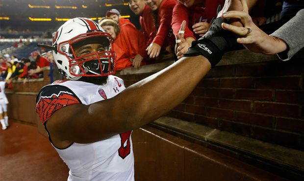 Nate Orchard #8 of the Utah Utes high fives fans fans after a 26-10 win over the Michigan Wolverine...