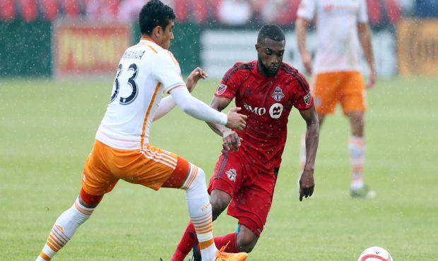 Ashtone Morgan #5 of Toronto FC battles with Leonel Miranda #33 of the Houston Dynamo during an MLS...