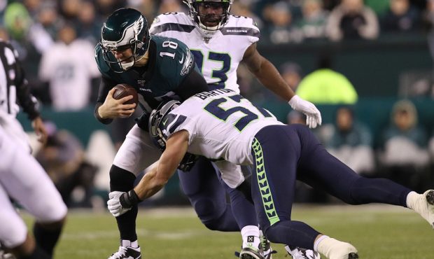 Backup quarterback Josh McCown #18 of the Philadelphia Eagles is tackled by Cody Barton #57 of the ...
