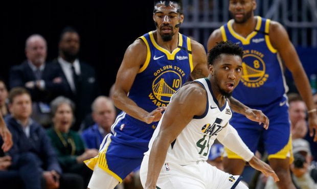 Utah Jazz guard Donovan Mitchell #45 loses control of the ball as he's guarded by Golden State Warr...