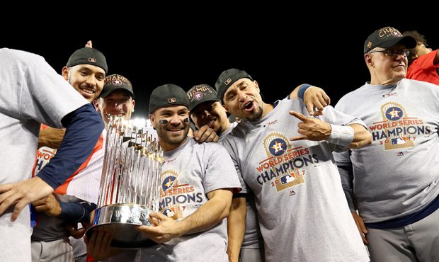 Jose Altuve #27 of the Houston Astros holds the Commissioner's Trophy after defeating the Los Angel...