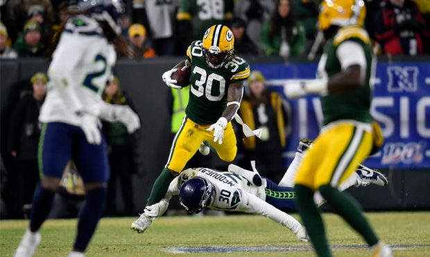 Jamaal Williams #30 of the Green Bay Packers runs the ball against Bradley McDougald #30 of the Sea...