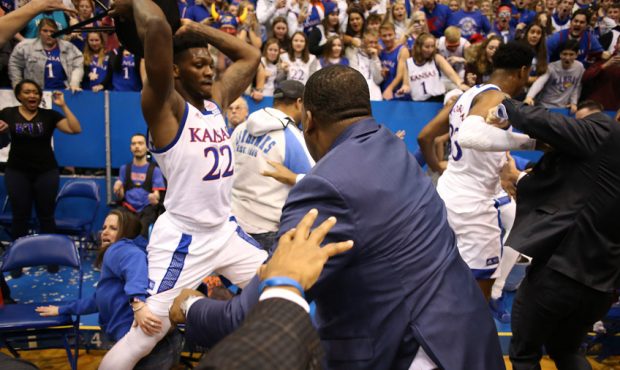 Silvio De Sousa #22 of the Kansas Jayhawks picks up a chair during a brawl as the game against the ...