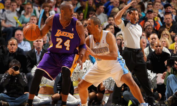 Kobe Bryant #24 of the Los Angeles Lakers controls the ball against Andre Miller #24 of the Denver ...