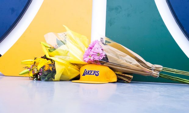 Flowers, Lakers Hat, Basketball Placed Next To Jazz Statue In Honor of Kobe Bryant