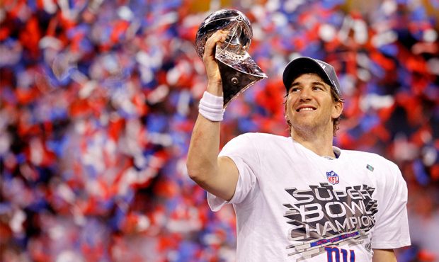 Quarterback Eli Manning #10 of the New York Giants poses with the Vince Lombardi Trophy after the G...