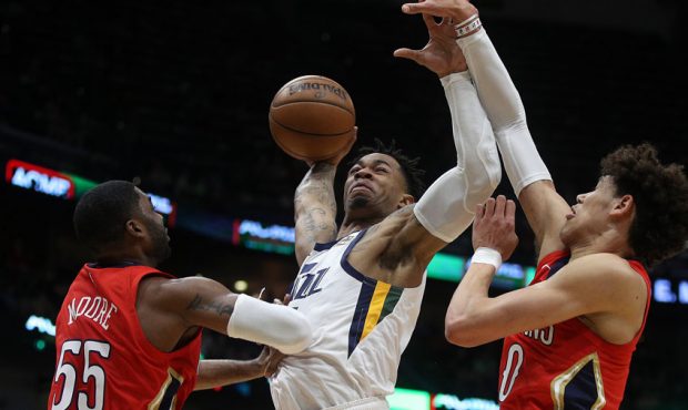 Rayjon Tucker #6 of the Utah Jazz dunks the ball over E'Twaun Moore #55 of the New Orleans Pelicans...